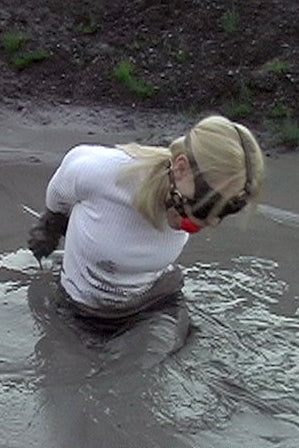 Person playing in a muddy puddle with a blurred background