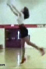 Person performing a high jump in an indoor sports facility with 'Williams' visible on the wall.