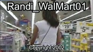 Woman shopping in a Walmart store aisle with products and shelves visible.