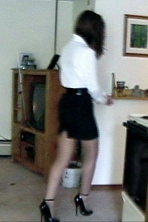 Person standing on a kitchen counter with a television and various items in the background